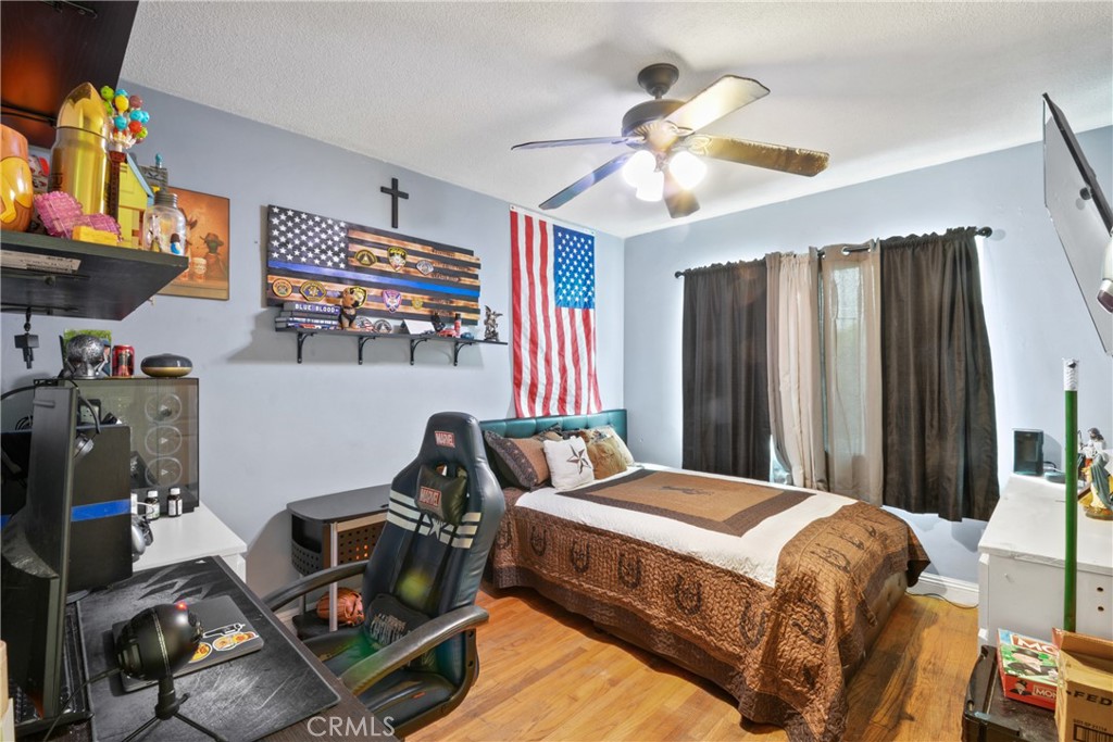 627 West Front Street Covina, CA 91722 - Photo 9 of 16 a bedroom with a bed and a chandelier