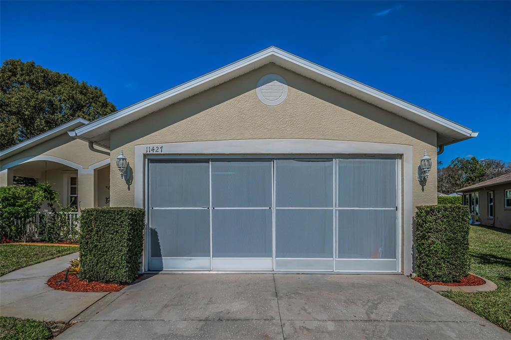 11427 Turtle Dove Place New Port Richey, FL 34654 - Photo 46 of 100 a front view of a house with a garden