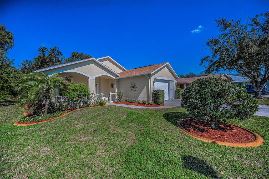 11427 Turtle Dove Place New Port Richey, FL 34654 - Photo 5 of 100 a front view of a house with a garden
