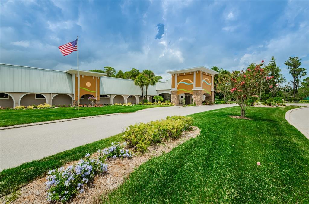 11427 Turtle Dove Place New Port Richey, FL 34654 - Photo 98 of 100 a front view of a house with a yard and potted plants