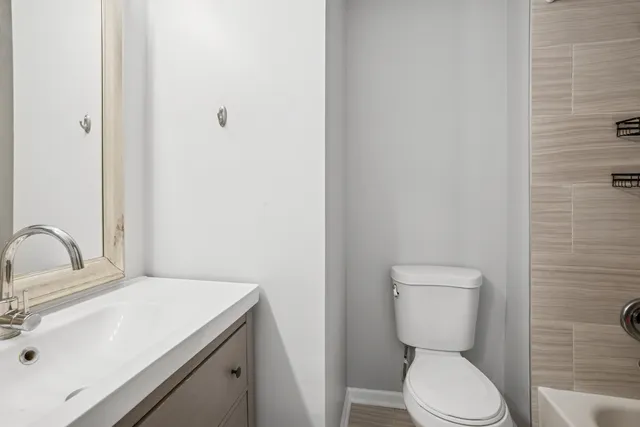 a bathroom with a sink toilet and vanity