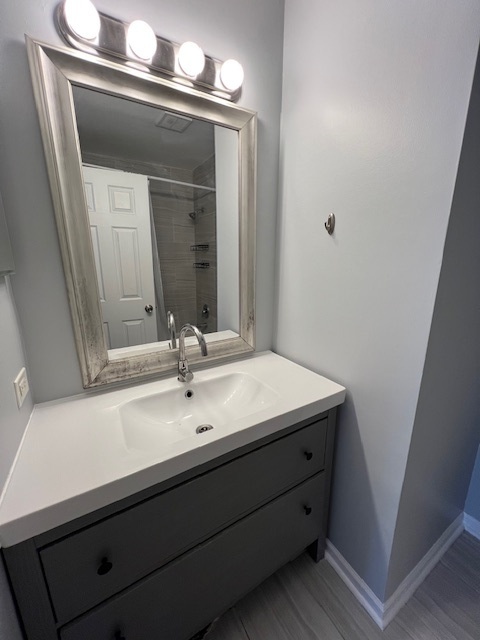 267 Cobblestone Court, Unit 267 Schaumburg, IL 60173 - Photo 16 of 19 a bathroom with a sink and a mirror