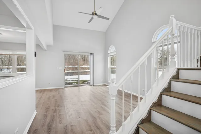 a view of an empty room with wooden floor and workspace