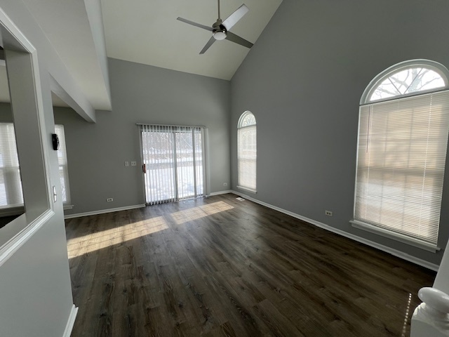 267 Cobblestone Court, Unit 267 Schaumburg, IL 60173 - Photo 2 of 19 wooden floor in an empty room with a window