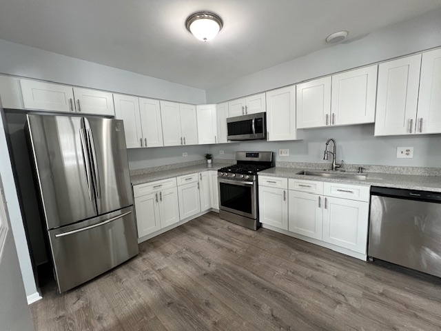 267 Cobblestone Court, Unit 267 Schaumburg, IL 60173 - Photo 7 of 19 a kitchen with white cabinets stainless steel appliances and a refrigerator