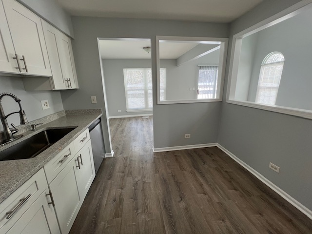 267 Cobblestone Court, Unit 267 Schaumburg, IL 60173 - Photo 10 of 19 a kitchen with wooden floors and white cabinets