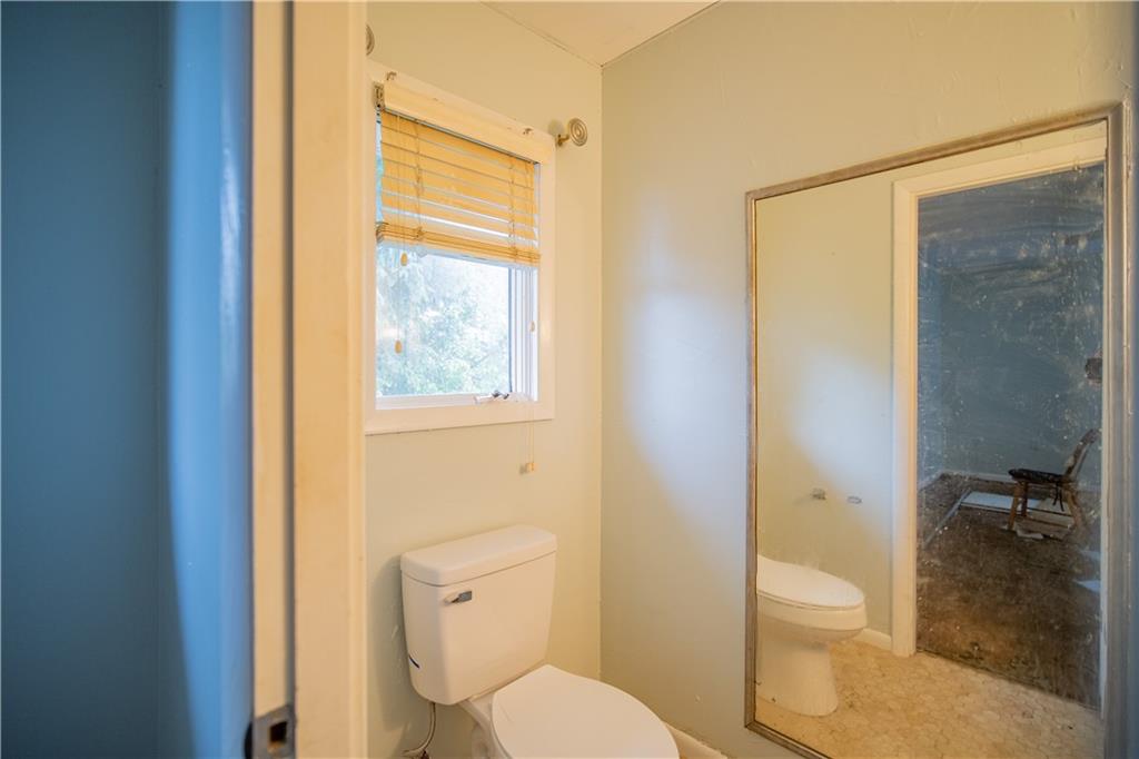 565 Jefferson Street Rochester, PA 15074 - Photo 8 of 12 a white toilet sitting next to a bathroom sink