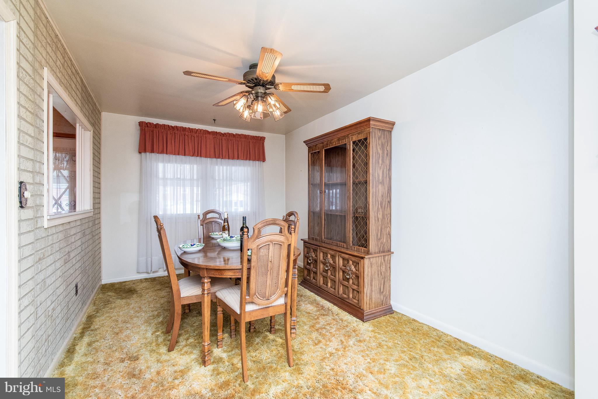 1621 Lynch Road Baltimore, MD 21222 - Photo 8 of 45 a dining room with furniture and window