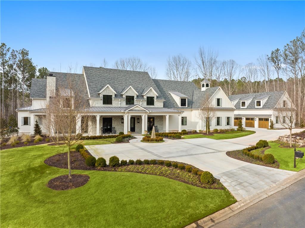 a front view of residential houses with yard and swimming pool