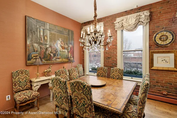 a dining room with furniture and wooden floor