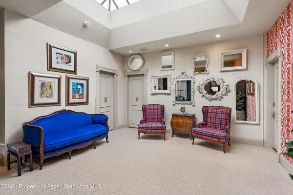 a living room with furniture and kitchen view