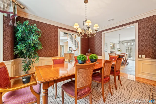 a view of a dining room with furniture and chandelier