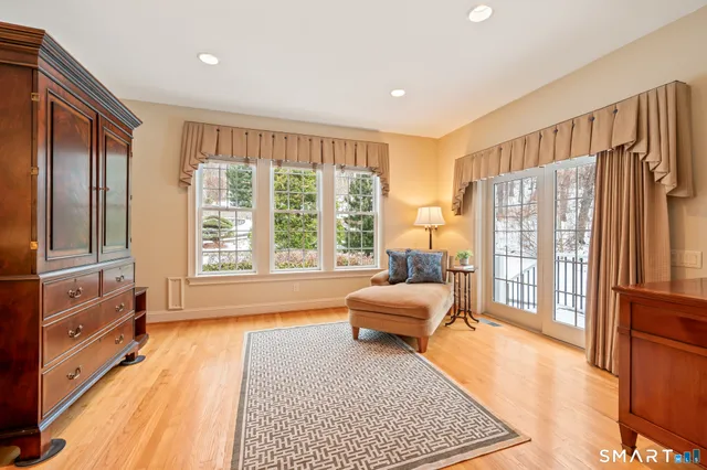a spacious bedroom with a large bed and a large window