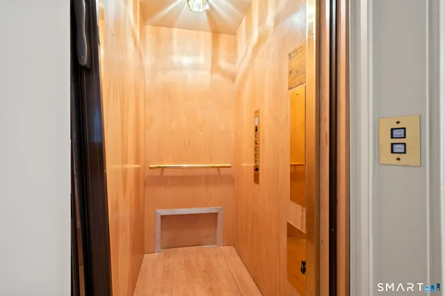 a view of entryway bedroom and hall with wooden floor