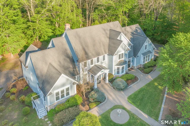 a aerial view of a house with backyard and garden