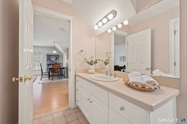 a living room with furniture a rug and a lamp
