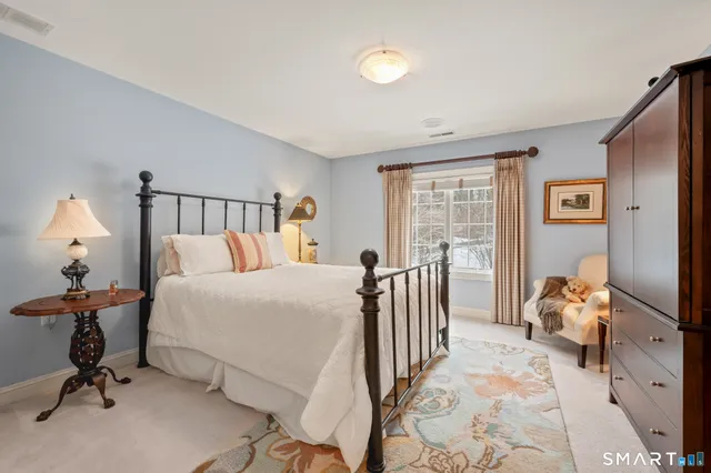 a bathroom with a granite countertop sink a toilet and mirror