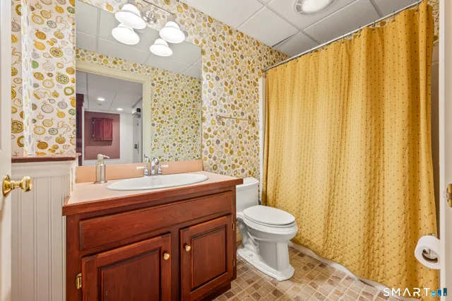 a patio with wooden floor a yard a table and chairs