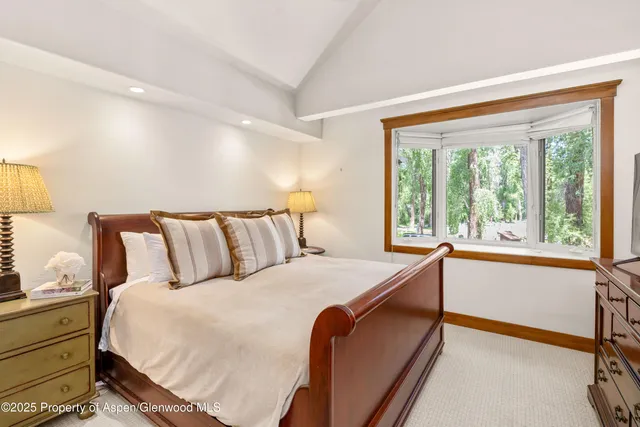 a bedroom with a large bed and a large window