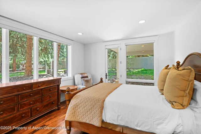 a bed room with a bed and a chair