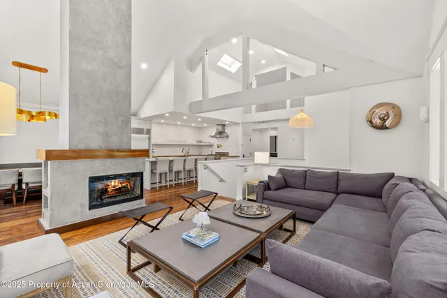 a living room with furniture fireplace and a table