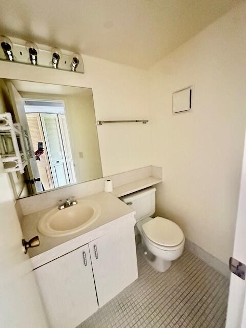 4014 Newcastle A Boca Raton, FL 33434 - Photo 6 of 33 a bathroom with a sink a toilet and a mirror