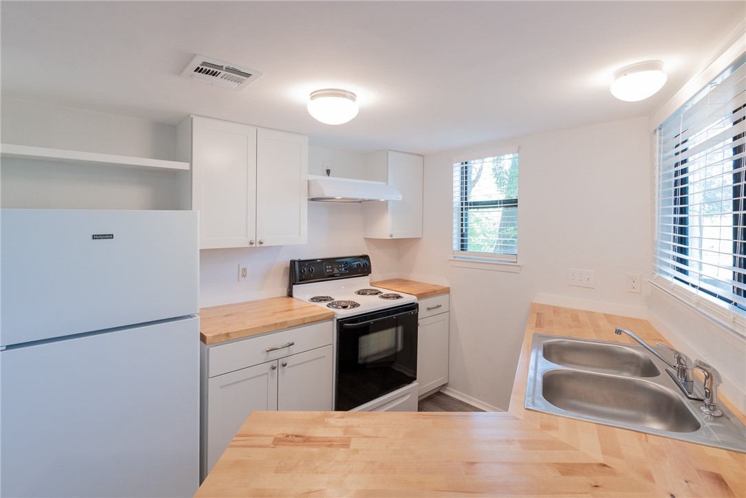 2500 Burleson Road, Unit 614 Austin, TX 78741 - Photo 7 of 20 a kitchen with a sink stove and cabinets
