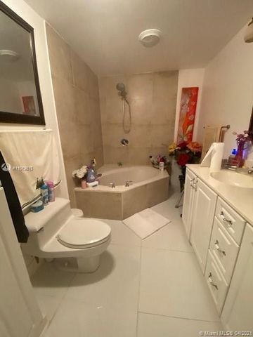 a bathroom with a sink a tub and a mirror