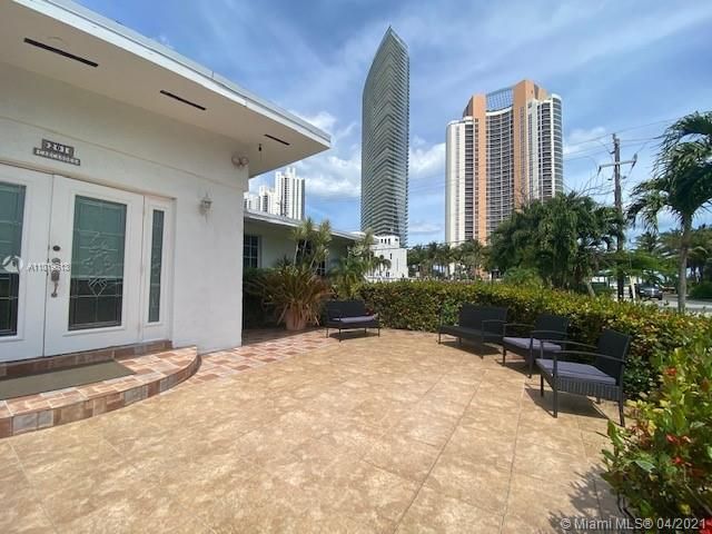 a view of a garden with a house in the background