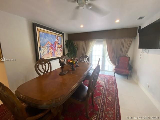 a kitchen with granite countertop a stove a sink and a refrigerator