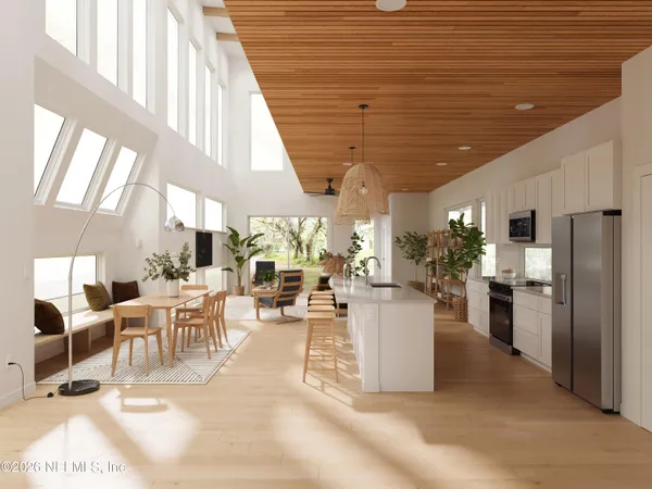 a living room with lots of white furniture and a dining table