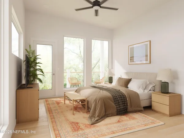 a spacious bedroom with a bed and glass window
