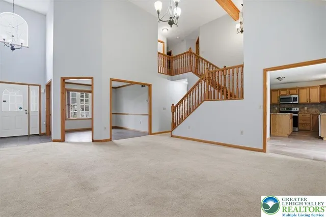 a kitchen with stainless steel appliances granite countertop a stove a sink dishwasher a microwave oven and a refrigerator with wooden floor