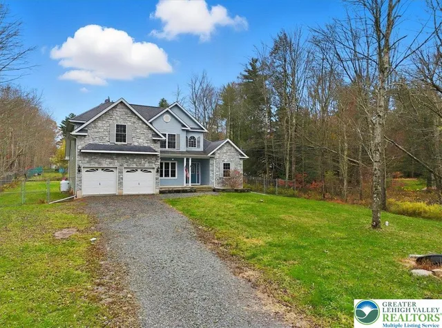 a view of a brick house with large windows