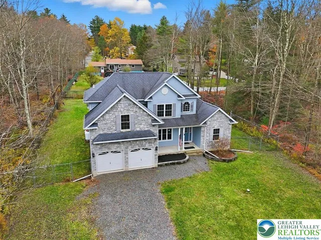 a view of an empty room with fireplace and a window