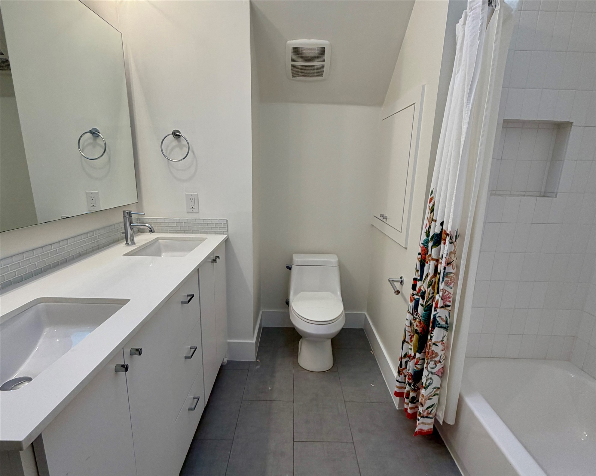 1515 Hether Street, Unit B Austin, TX 78704 - Photo 21 of 30 A sleek dual vanity and shower-tub combo create a functional and pleasant bathroom space.