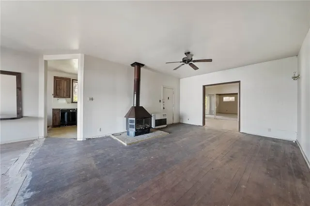 a view of an empty room with a fireplace and a large window