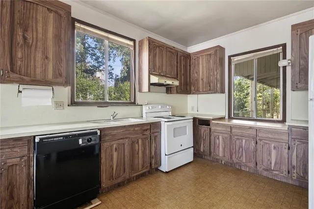 a kitchen with a sink appliances and cabinets