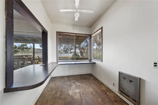 a view of a room with window and a ceiling fan
