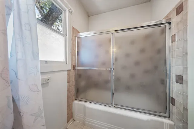 a view of a livingroom with wooden floor and a window