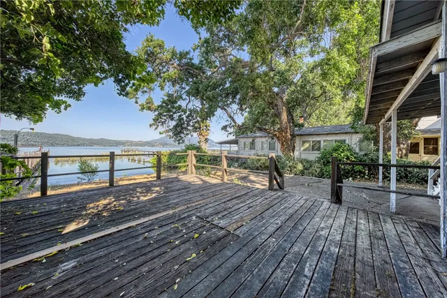 a view of a yard with wooden fence