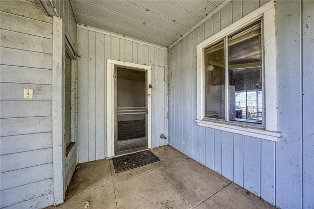 a view of room with hardwood floor and a ceiling fan