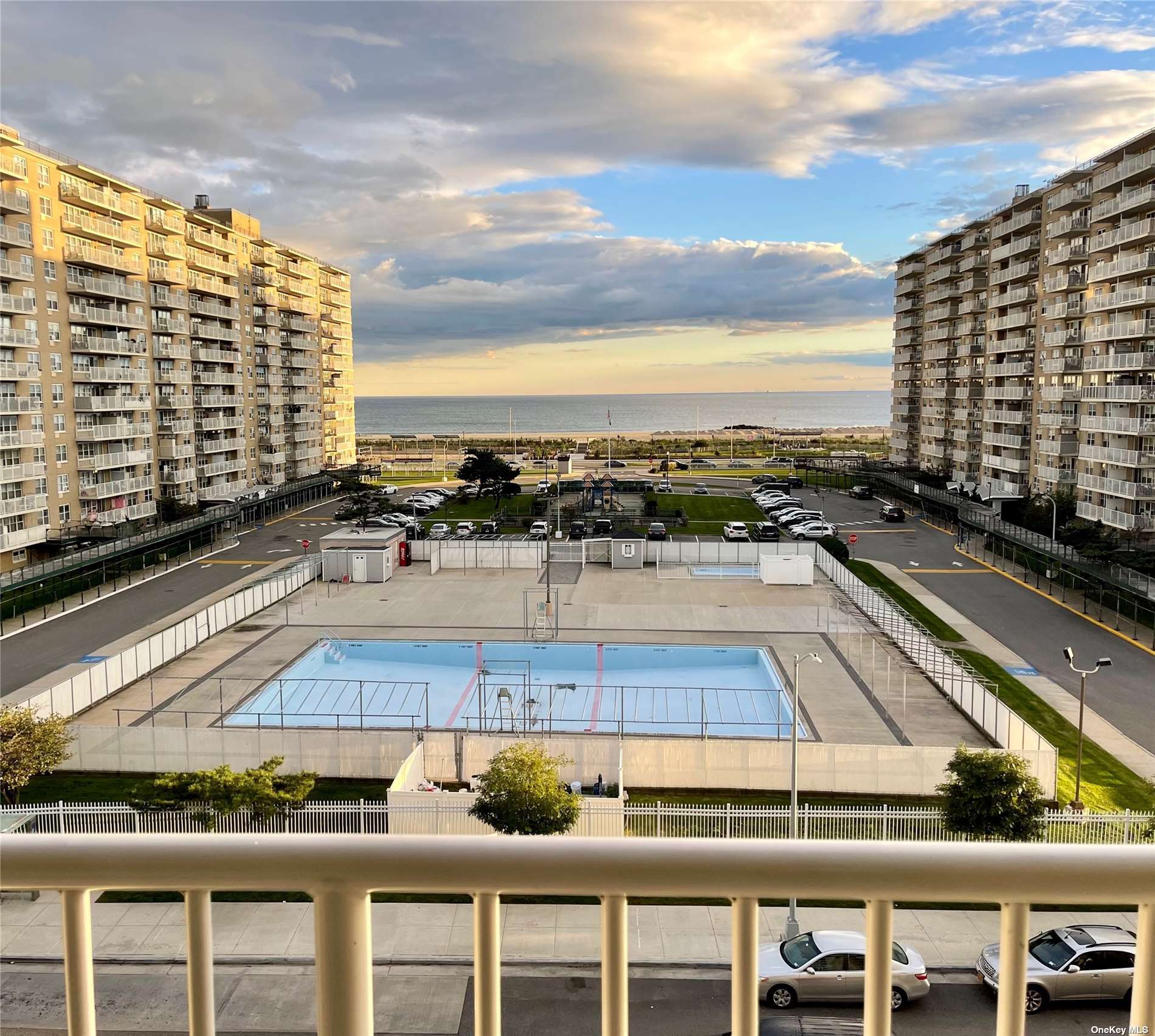 a view of swimming pool with outdoor seating and buildings in the background