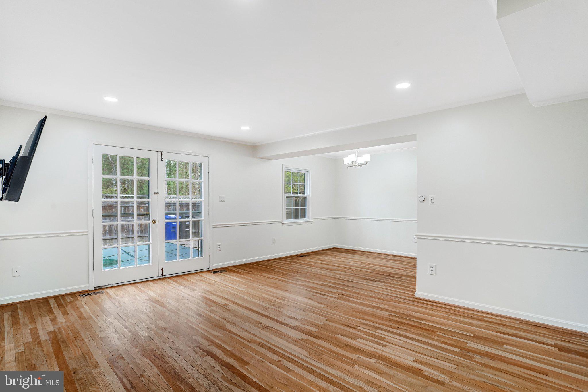 9752 Cardinal Road Fairfax, VA 22030 - Photo 11 of 37 an empty room with wooden floor and windows