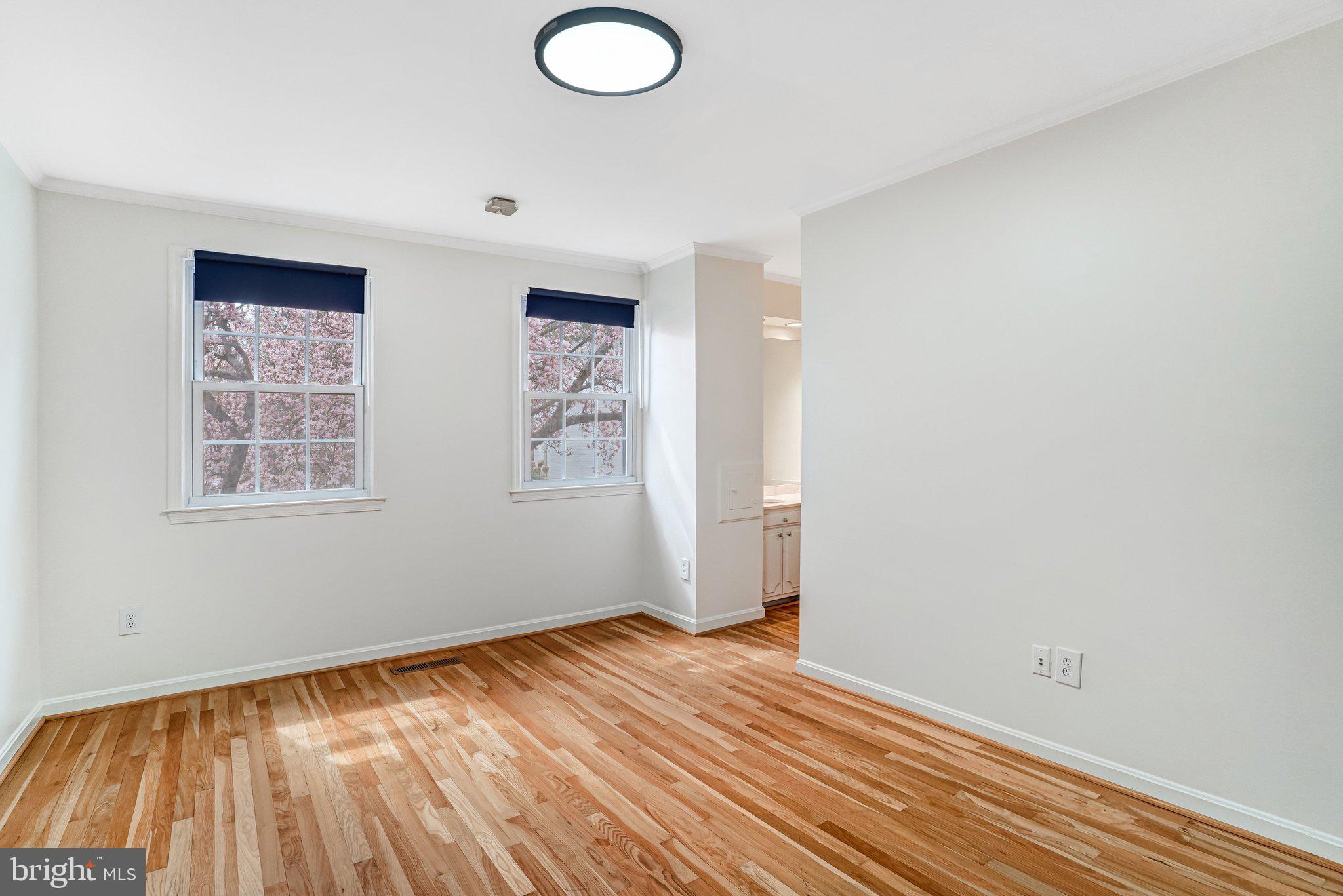 9752 Cardinal Road Fairfax, VA 22030 - Photo 17 of 37 an empty room with wooden floor and windows