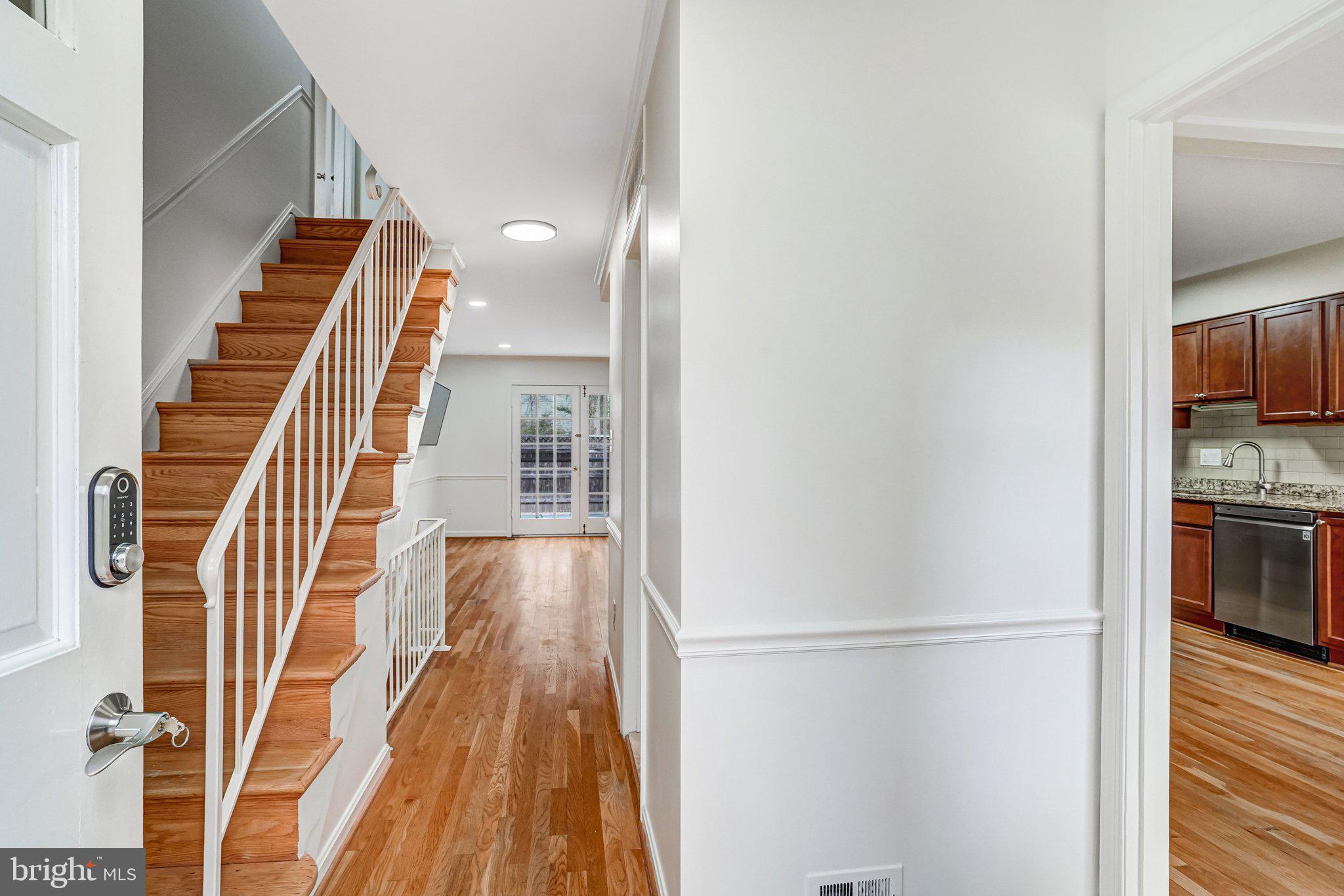 9752 Cardinal Road Fairfax, VA 22030 - Photo 2 of 37 a view of a hallway with wooden floor and staircase