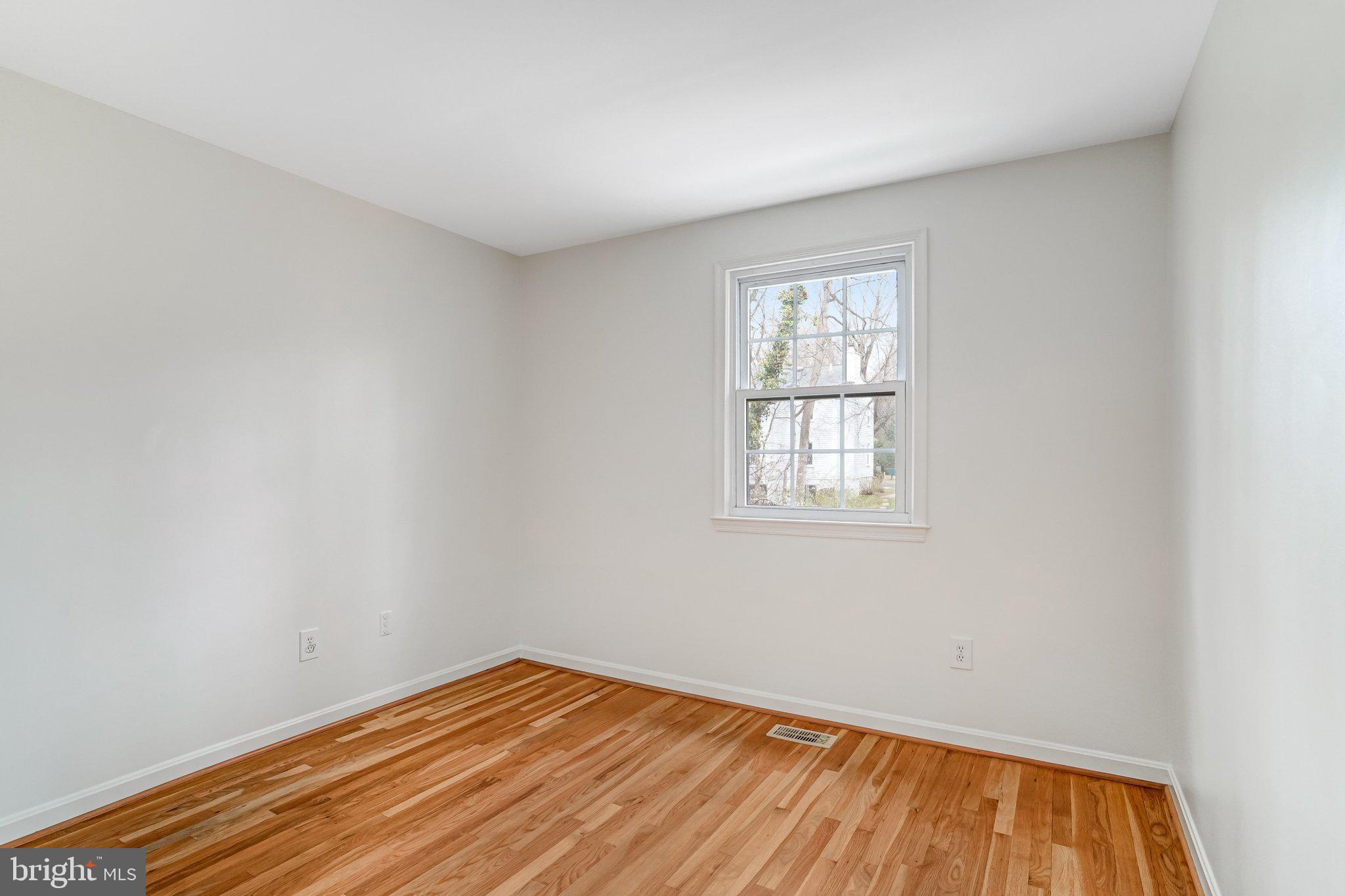 9752 Cardinal Road Fairfax, VA 22030 - Photo 24 of 37 wooden floor in an empty room with a window