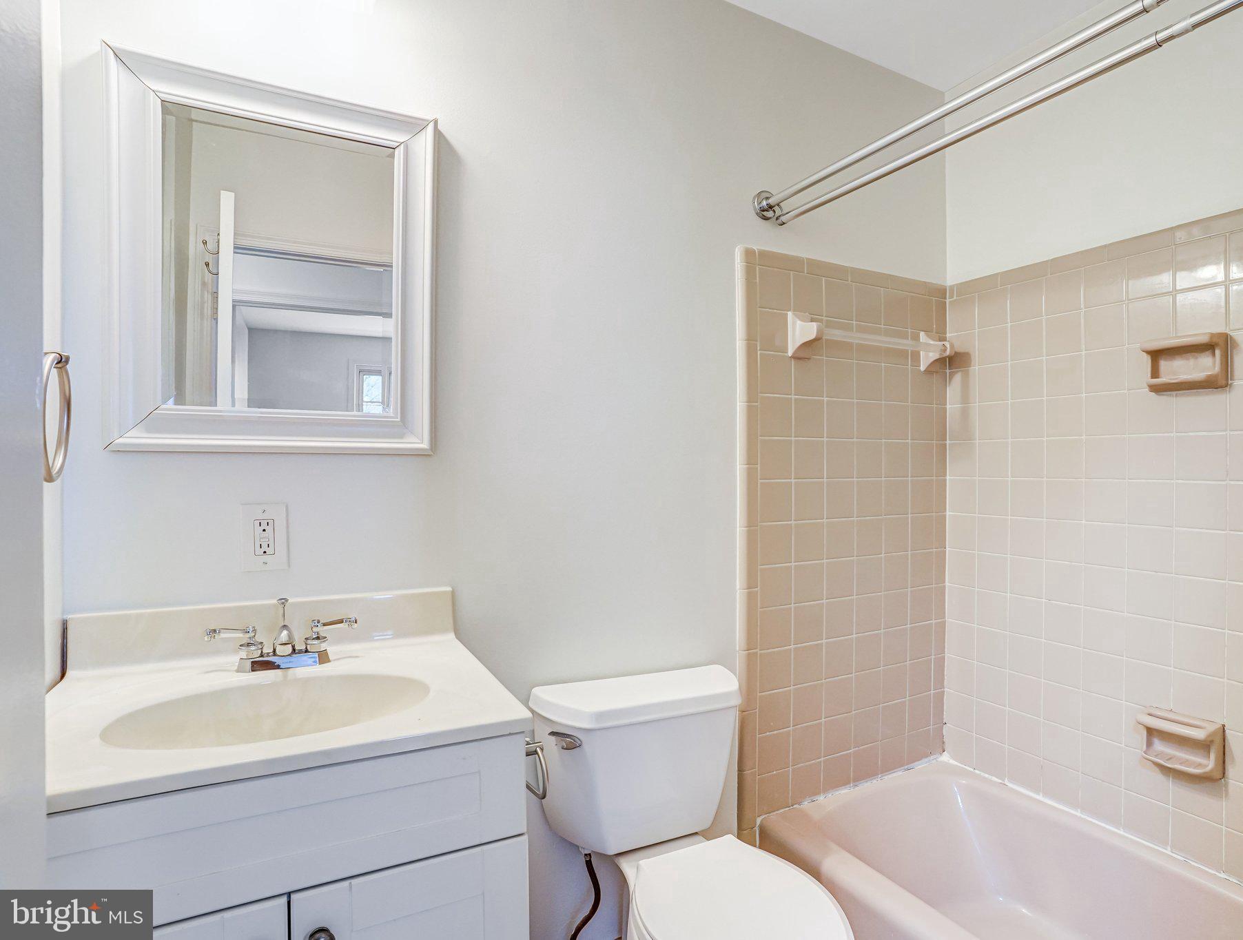 9752 Cardinal Road Fairfax, VA 22030 - Photo 27 of 37 a bathroom with a sink toilet vanity and tub