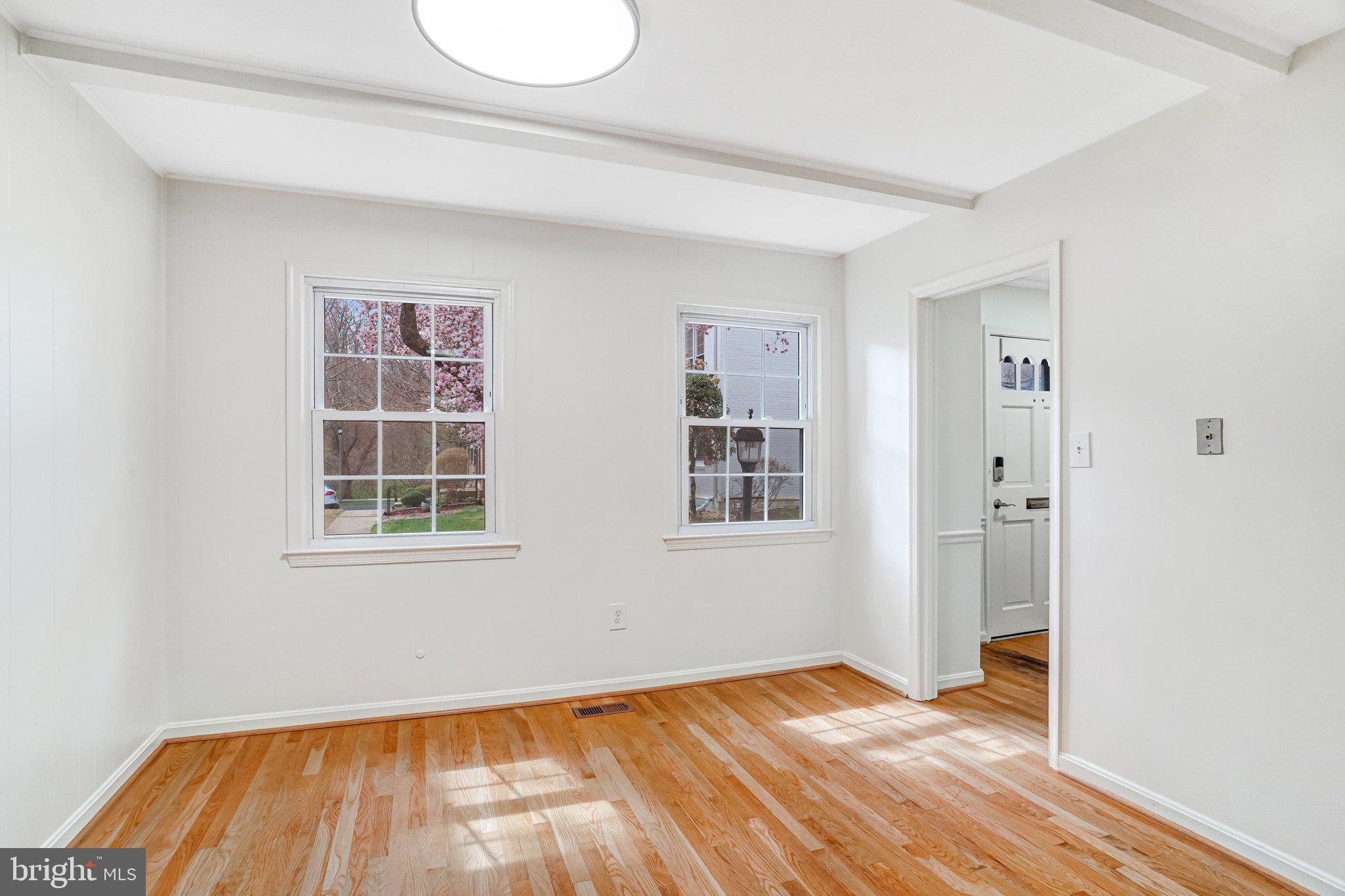 9752 Cardinal Road Fairfax, VA 22030 - Photo 3 of 37 an empty room with wooden floor and windows