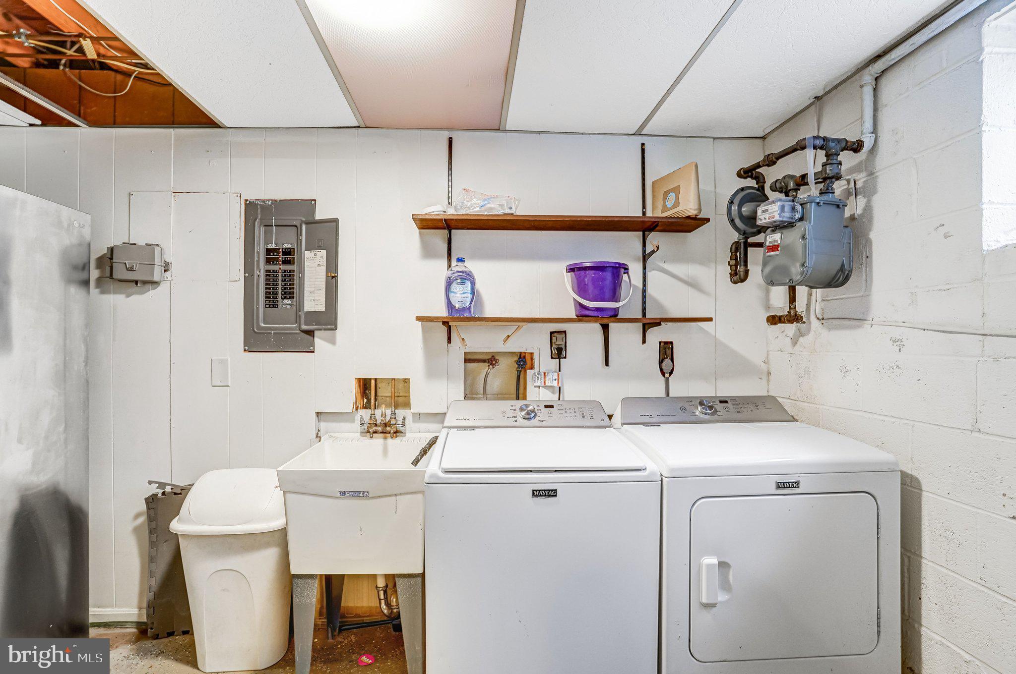 9752 Cardinal Road Fairfax, VA 22030 - Photo 33 of 37 a utility room with a sink dryer and washer